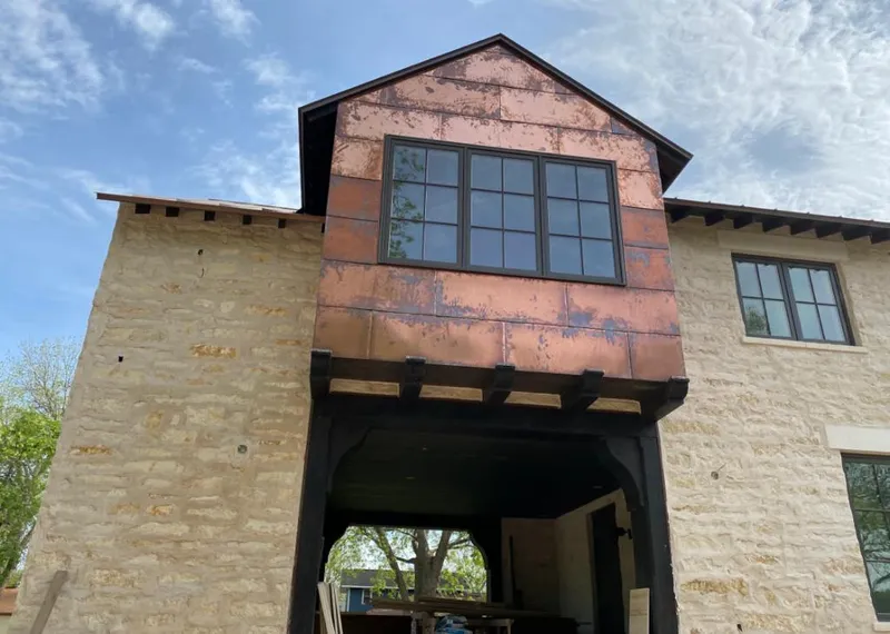 Copper metal panel facade on a stone building for Roof Repair in Lake Morton-Berrydale
